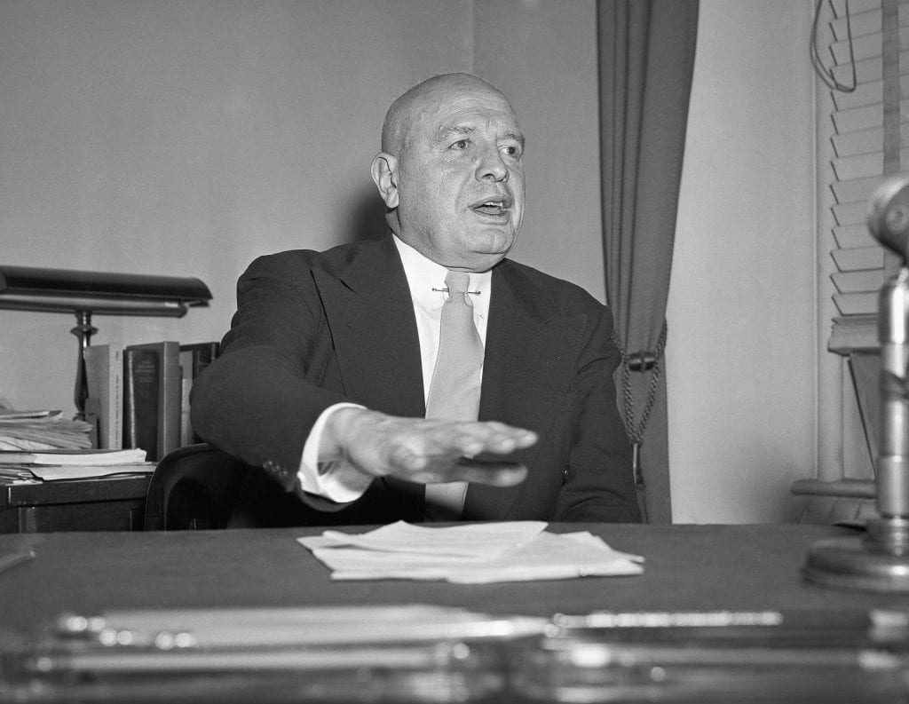 Harry Anslinger sitting at a desk with legal documents 1954 announcing crackdown on drugs