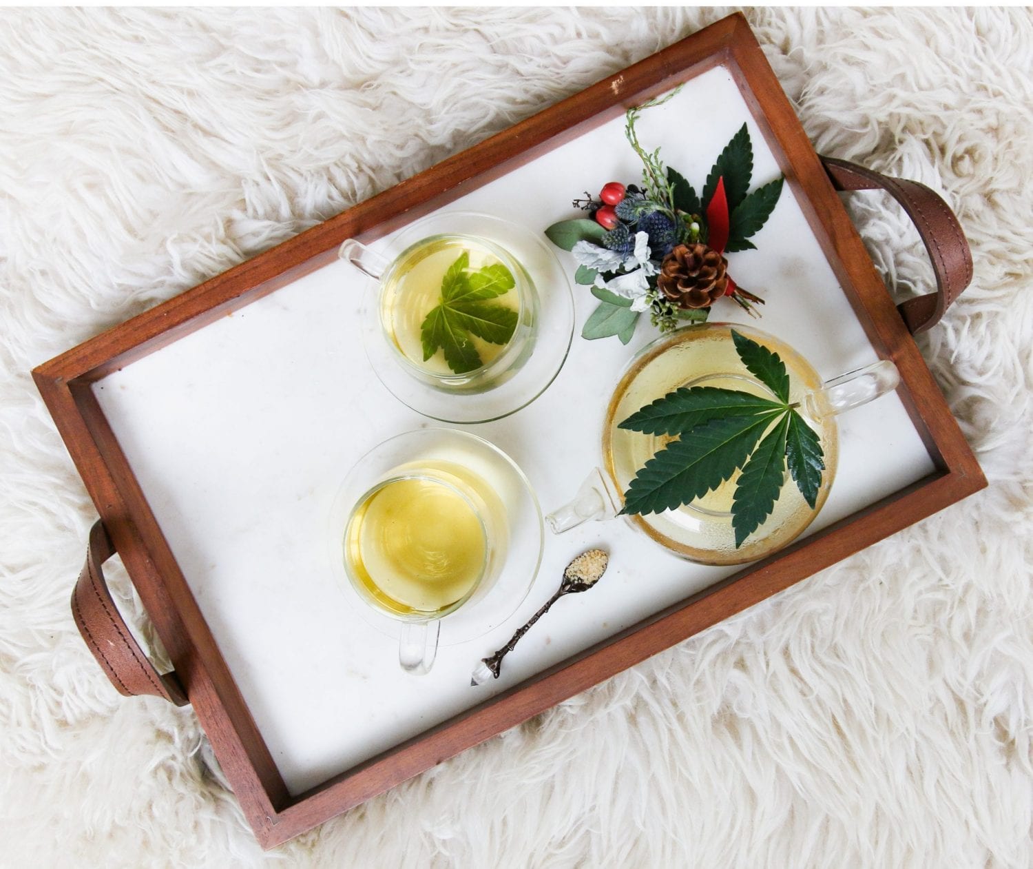 3 glasses of tea with cannabis leaves, CBD oil, and CBD salts