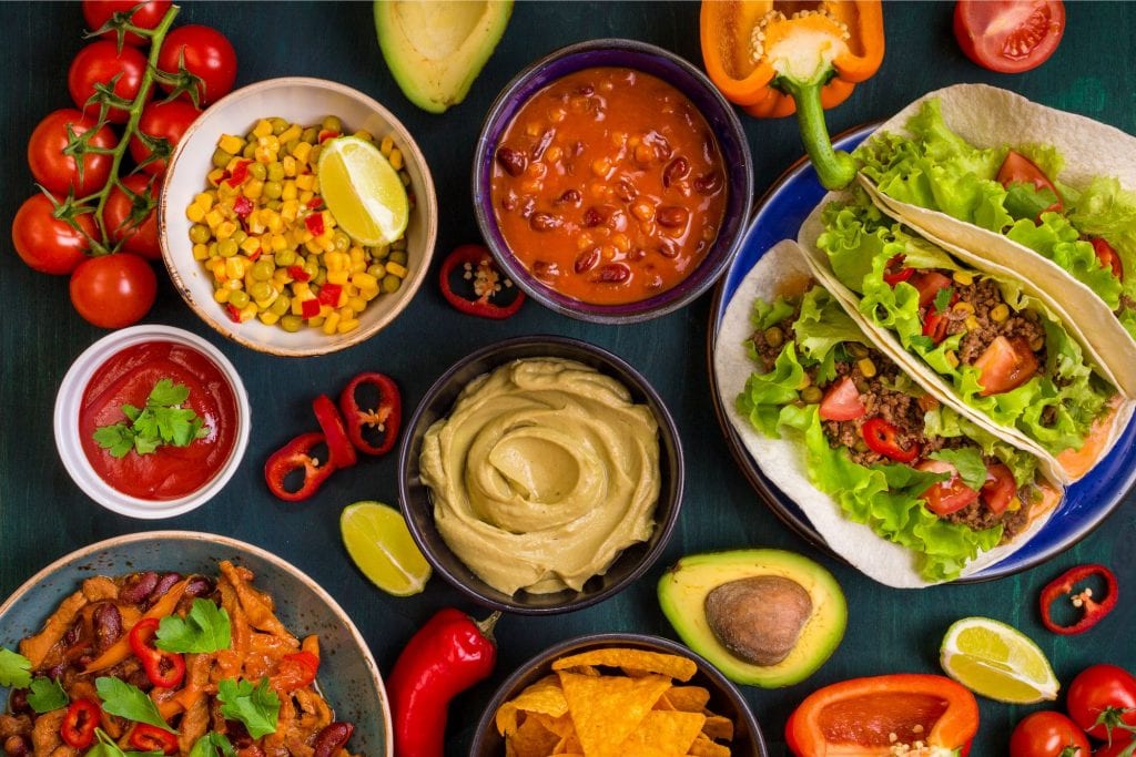 Overhead shot of all the ingredients used to make Mexican food including tacos