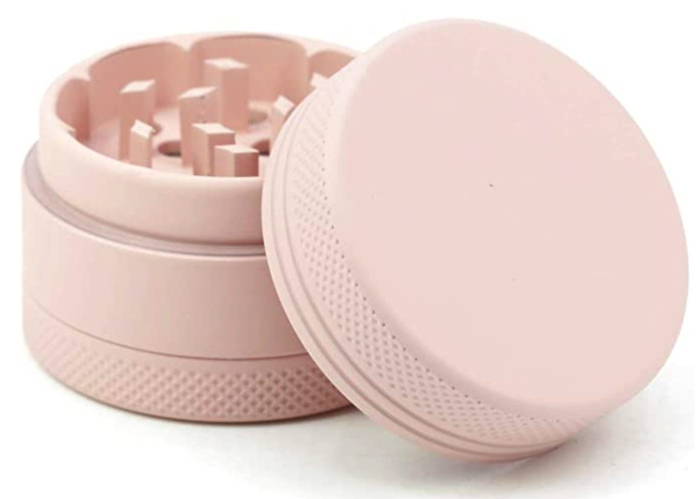 pink Dreamen Ultra mini Portable Grinder with the lid open on a white table